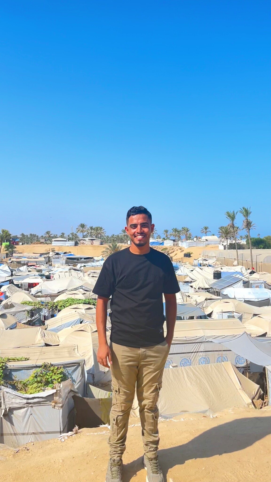 Let Hope Rise Gaza organizer standing above a displacement camp in Gaza