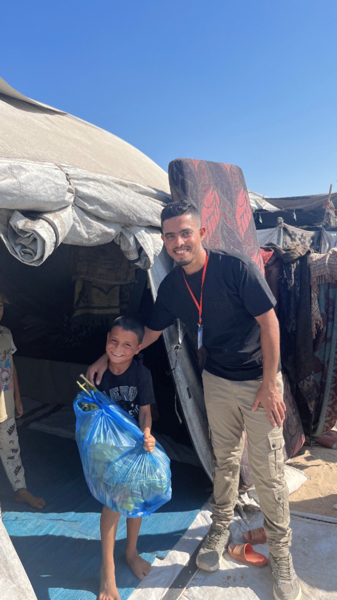 An aid delivery to a child at a displacement shelter in Gaza